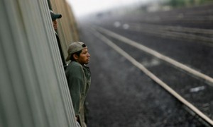 Immigrants travel on a cargo train to the border city of Nuevo Laredo, Mexico